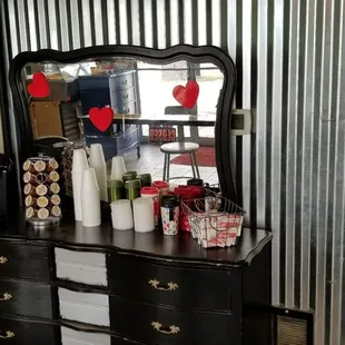 a black dresser with a mirror