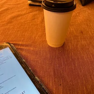 a cup of coffee and a cell phone