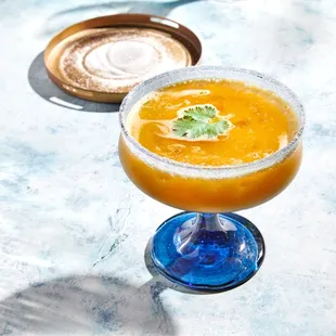 a glass of orange juice on a table