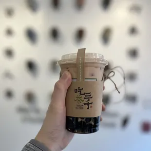 a hand holding a cup of coffee