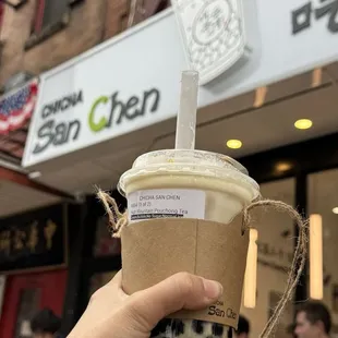 a hand holding a cup of coffee