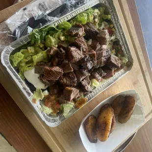 Carne Asada- Pan seared churrasco steak topped with our house made chimichurri. Side of rice, beans and plantain.