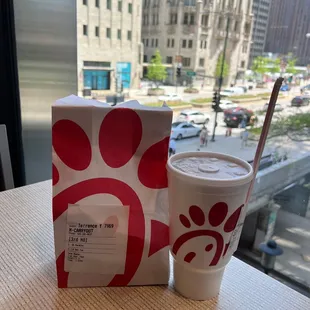 ows a cup of coffee and a box on a table