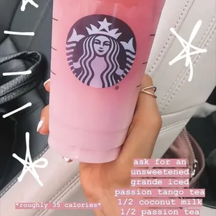 ows a person holding a starbucks drink