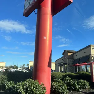 ows a large red sign in front of a restaurant