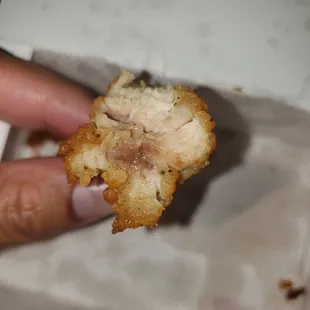 ows a person holding a piece of food