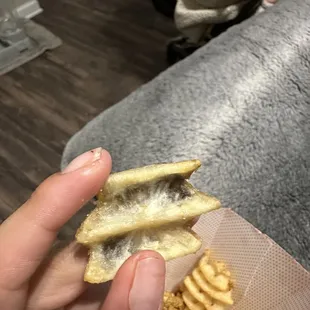 ows a person holding a piece of food