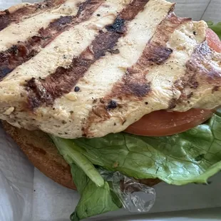 Grilled chicken sandwich with lettuce, tomatoes, and plastic???