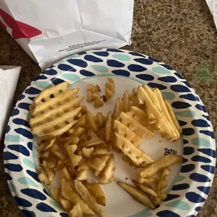 ows a plate of waffles and fries