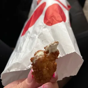 ows a person holding a piece of food