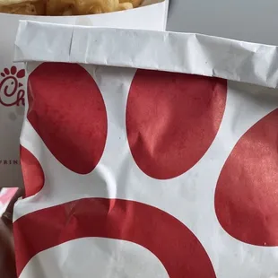 ows a person holding a bag of fries