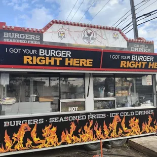 a hot dog cart with flames on it