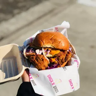  hand holding a sandwich