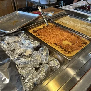 Display of baked potatoes, Mac and cheese, and rice