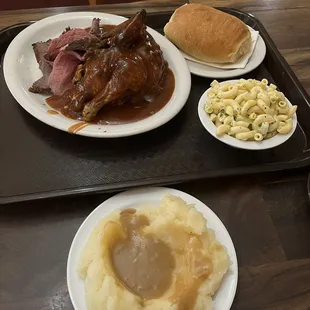 Bbq chicken, roast beef, mac salad, mashed potatoes and a side of bread and butter m.