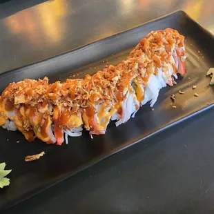 Crunch Salmon Roll: salmon, avocado, jalapeno, crab, spicy mayo, eel sauce, jalapeno sauce, fried onions, spicy herbs