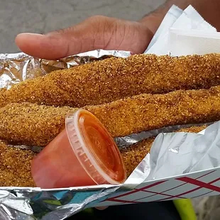 a person holding a basket of chicken nuggies