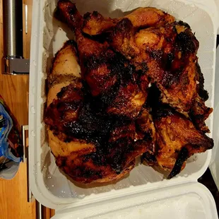 a chicken in a styrofoam container