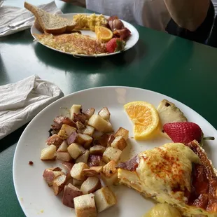 Quiche of the day- vegetarian with cottage fries.  Behind- eggs, bacon, hash browns and toast.