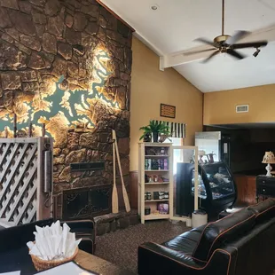 a living room with a stone fireplace