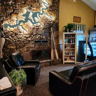 a living room with a stone fireplace