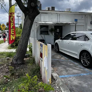  a white car parked in a parking lot