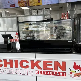 a restaurant counter with a sign that says chicken avenue