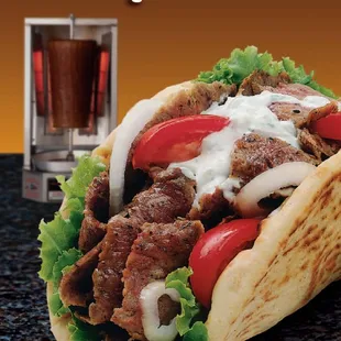 a gyros with lettuce and tomatoes