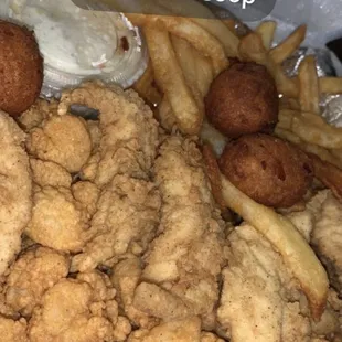 Seafood and strips (calabash shrimp and chicken strips) with fries, hush puppies, and slaw