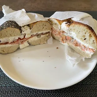 Pastrami lox sandwich on everything bagel and smoked trout sandwich on onion bagel