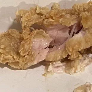 a half eaten chicken sandwich