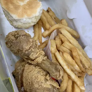 a chicken sandwich, french fries, and a biscuit
