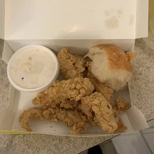 a box of fried chicken and a bowl of ranch dip