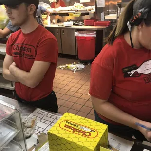 we wonder why it was wrong. This is a new trainee with his arms folded in front of the manager with piles and piles of trash on the floor.