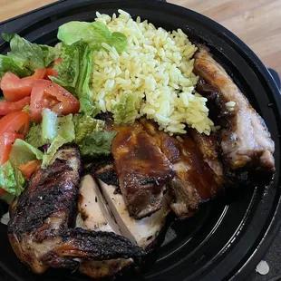 a plate of chicken, rice, and salad