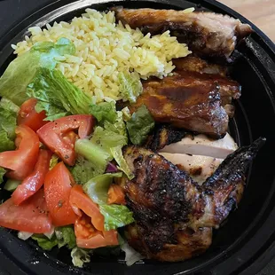 a plate of chicken, rice, and vegetables