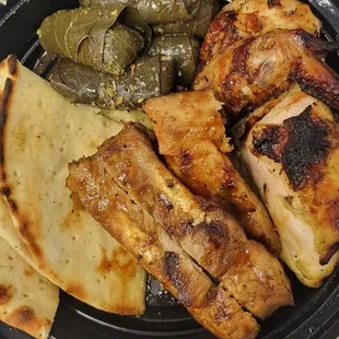 Chicken and ribs with dolmades.