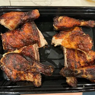 chicken legs in a black tray