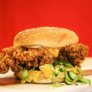 a chicken sandwich on a cutting board