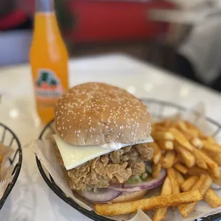 two baskets of fries and a burger