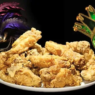 a plate of fried chicken and a mask