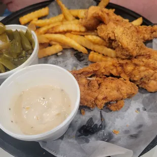 Chicken tenders, green beans, fries, and gravy.