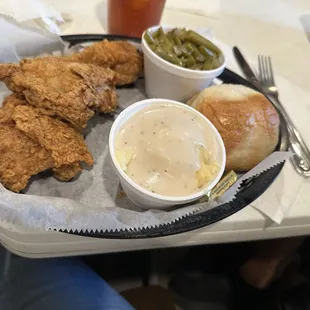 Dark meat fried chicken with green beans and mashed potatoes and gravy