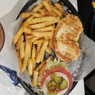 Dressed chicken sandwich and fries