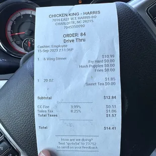 a receipt on the steering wheel of a car