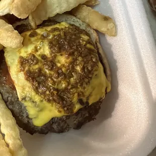 cheeseburger and fries in a styrofoam container