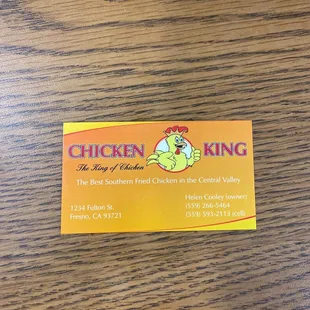 a yellow business card on a wooden table
