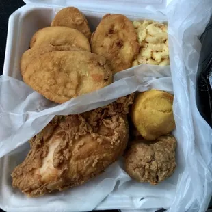 Fried chicken with fried squash, macaroni and cheese and cornbread muffin.