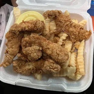 fried chicken and french fries in a styrofoam container