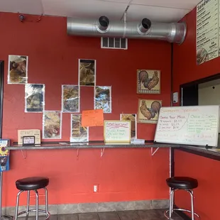 a counter with a menu and two stools